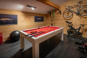 a ping pong table in a room with a ping pong ball at Chalet Paravis - OVO Network in La Clusaz
