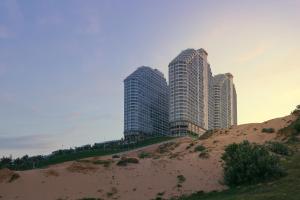 two tall buildings sitting on top of a sand hill at Mandala Cham Bay Mui Ne in Ấp Thiẹn Ái