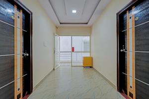 an office corridor with doors and a yellow chair at OYO 19749 New Shelton Suites in Yelahanka