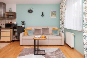 un soggiorno con divano e tavolo di Subtle and Cosy Studio with Furnished Balcony in Gdańsk by Renters a Danzica