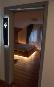 a mirror reflecting a bedroom with a bed in a room at Walthouse in Vulcan