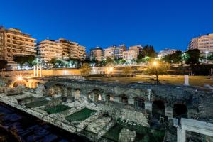 an ancient amphitheater in a city at night at Luxury Downtown Apartment Α1 in Thessaloniki