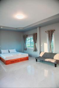 a bedroom with two beds and a window at Blessing Pua in Ban Lao