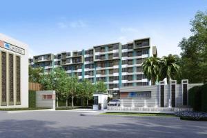 a large building with a palm tree in front of it at Centrio Condo CENTRAL PHUKET c419 in Ban Rangeng