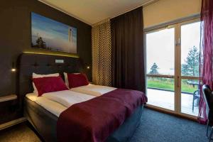 Postel nebo postele na pokoji v ubytování Hotell Höga Kusten