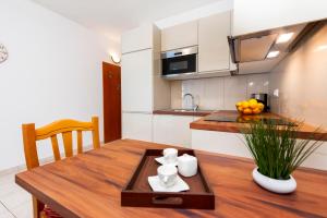 - une cuisine avec une table en bois et une salle à manger dans l'établissement Apartments Mirela, à Rovinj