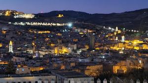 a view of a city at night at Center Medina in Fez