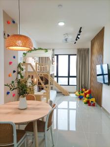 a living room with a dining table and a play room at Japandi Family Play Suite with Slide Bunk Bed in Kajang