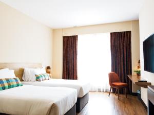 Postel nebo postele na pokoji v ubytování Starus Hotel Bukit Bintang