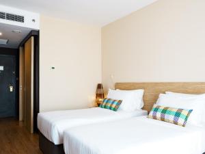 Postel nebo postele na pokoji v ubytování Starus Hotel Bukit Bintang