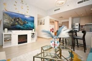 a living room with a fireplace and a dining room at Yas Island 2 BR Turquoise in Abu Dhabi