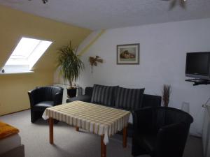 a living room with a couch and chairs and a table at Ferienzimmer Wenzel in Hasselfelde
