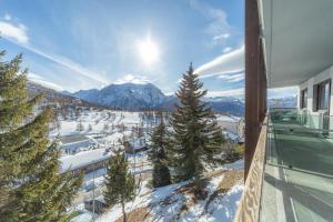 a view of a snowy mountain from a house at Hotel Gran Roc in Sestriere