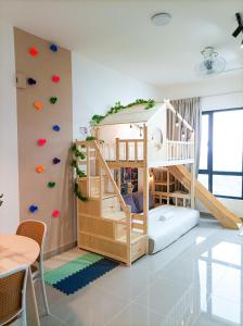 a childs room with a bunk bed and a staircase at Japandi Family Play Suite with Slide Bunk Bed in Kajang