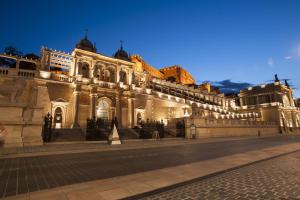 a large building with lights on it at night at Elisabeth Bridge Apartmans in Budapest