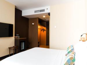 Postel nebo postele na pokoji v ubytování Starus Hotel Bukit Bintang
