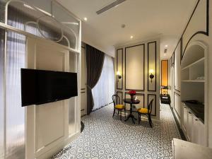 a hotel room with a flat screen tv on a wall at Le Bonheur Hotel in Phú Quốc