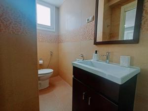 a bathroom with a sink and a toilet at Caminos del Mediterráneo in Castellón de la Plana