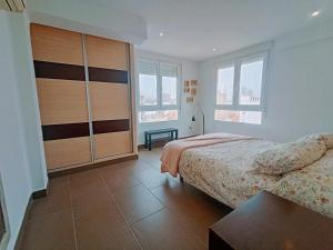 a bedroom with two beds and a large closet at Caminos del Mediterráneo in Castellón de la Plana