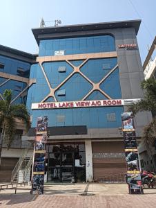 a building with a sign on the front of it at Hotel Lake View AC room in Vadodara