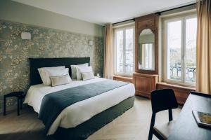 a bedroom with a large bed in a room with windows at Maison MARIE in Saint-Maur-des-Fossés +27 photos
