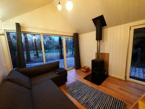 a living room with a couch and a wood stove at Ramybės parkas in Sponėnai