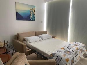 a living room with a bed and a couch at Green Door Getaway in Limassol