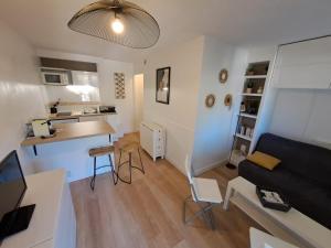 a small apartment with a kitchen and a living room at Mazet T2 - Domaine de la Pinède - Piscine Chauffée in Le Lavandou
