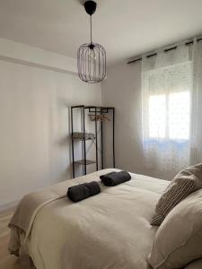 a bedroom with a large bed with two pillows on it at Apartamento en Centro - Vial in Córdoba