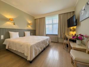 Voodi või voodid majutusasutuse Hotel Pavillon Du Zoute toas