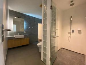 a bathroom with a toilet and a sink and a shower at Tropical 1bedroom Apartment in Kamala Beach