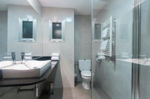a bathroom with a sink and a toilet at Hotel Lauria in Tarragona