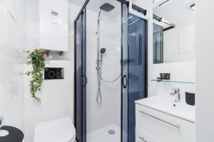 a bathroom with a shower and a sink at STU Theater Underground Apartment Syrokomli by Renters in Krakow