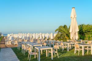 a bunch of tables and chairs with umbrellas at Side Story Resort & Spa in Side