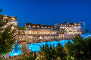 a resort with a swimming pool at night at Side Story Resort & Spa in Side