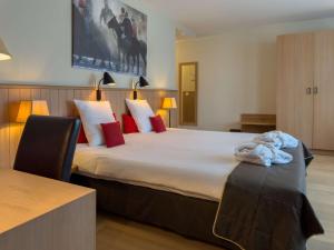 Voodi või voodid majutusasutuse Hotel Pavillon Du Zoute toas