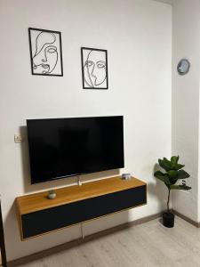 a flat screen tv sitting on a wall in a living room at Kod Dide - entry with pin 0-24h in Slavonski Brod