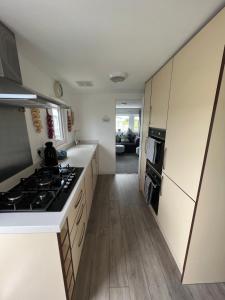 a kitchen with white cabinets and a stove top oven at The Vale @Barmston in Barmston