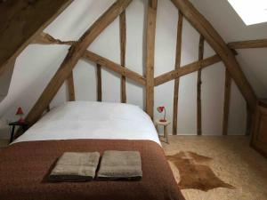 a bedroom with a bed in an attic at Les Bleuets in Rue