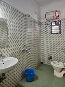 a bathroom with a sink and a toilet at SSJ Premium in Bhubaneshwar