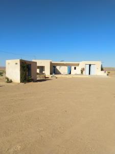 a building in the middle of the desert at DAR BRAHIM 
