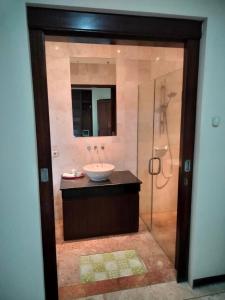 a bathroom with a sink and a shower at Villa Layang Bulan - Male Only in Denpasar