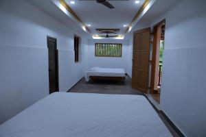 a bedroom with a bed and a window at Best Heritage Home in Iritti +10 photos