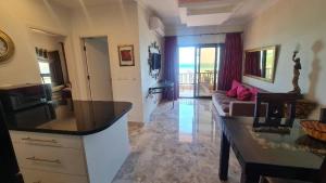 a living room with a couch and a table at Beach Front View Boutique Apartment in Hurghada