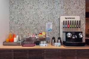 a coffee station with a coffee maker on a counter at Hotel Lauria in Tarragona
