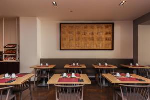 a dining room with tables and a calendar on the wall at Hotel Lauria in Tarragona