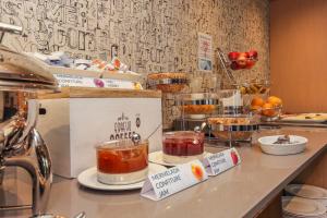 a kitchen with a counter with food in jars on it at Hotel Lauria in Tarragona
