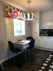 a kitchen with a table and chairs and a window at SARA - Modern Row Aprt with Sauna - 24h Check-in in Närpiö