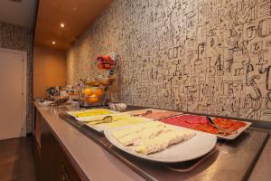 a buffet with cheese and other foods on a counter at Hotel Lauria in Tarragona