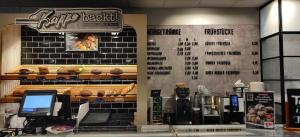 a fast food restaurant with a menu on the wall at Pension Ramser in Lindhorst